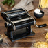 Pasta maker with fresh pasta on a wooden surface