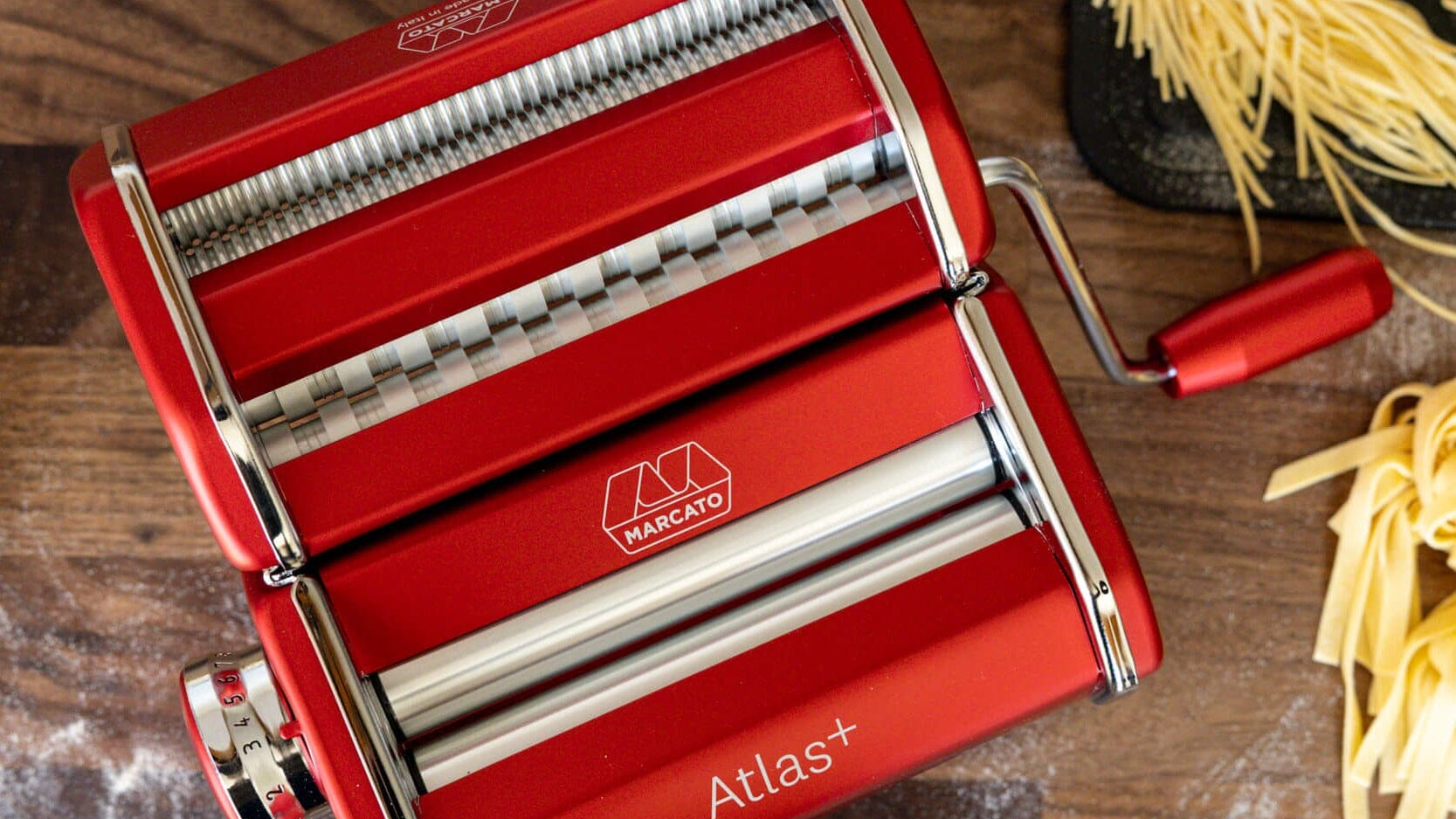 Red Atas + Pasta MAchine on a wooden table with home made pasta