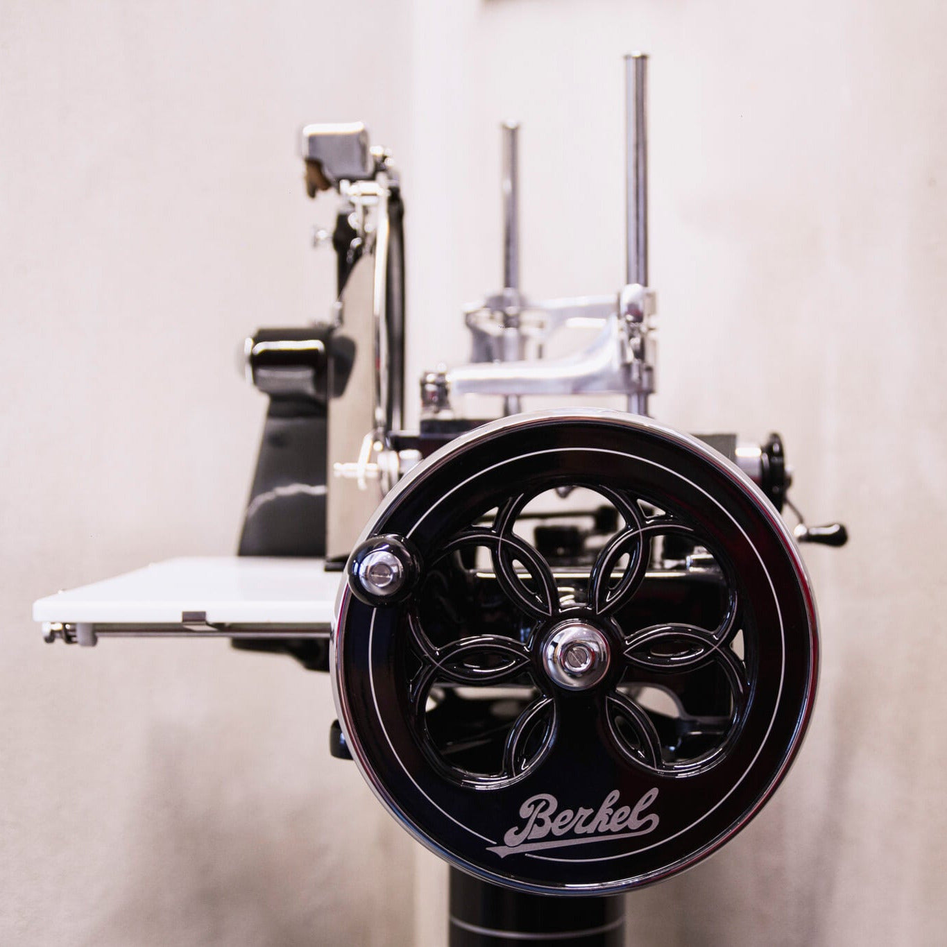 Close-up of a black Berkel Volano P15 slicerwith visible branding on a neutral background