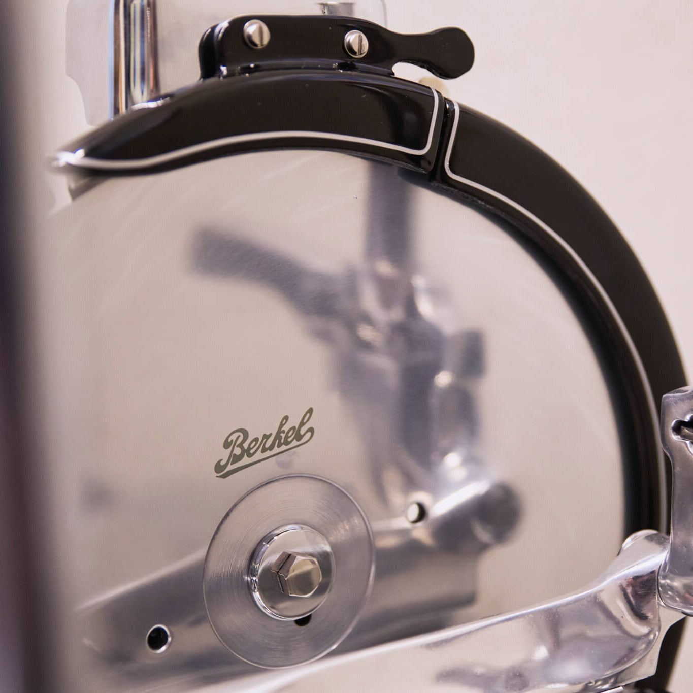 Close-up of a Berkel Volano P15 flywheel slicer showing branding on the cutting blade
