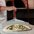 Pizzaioli using Cerutti Inox Tulip Pizza Peel to pick up a neopolitan style pizza.
