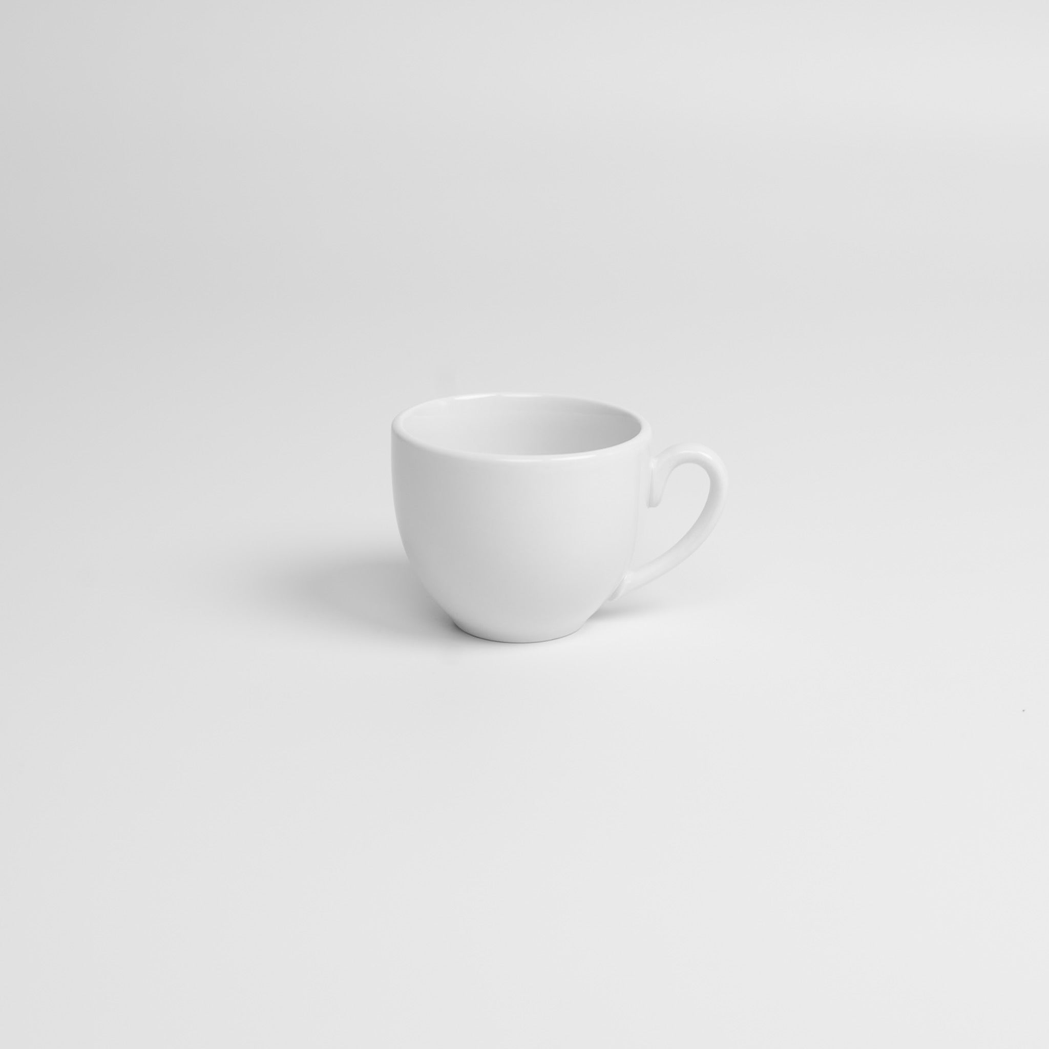 White porcelain cup on a light gray background