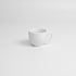 White porcelain cup on a light gray background