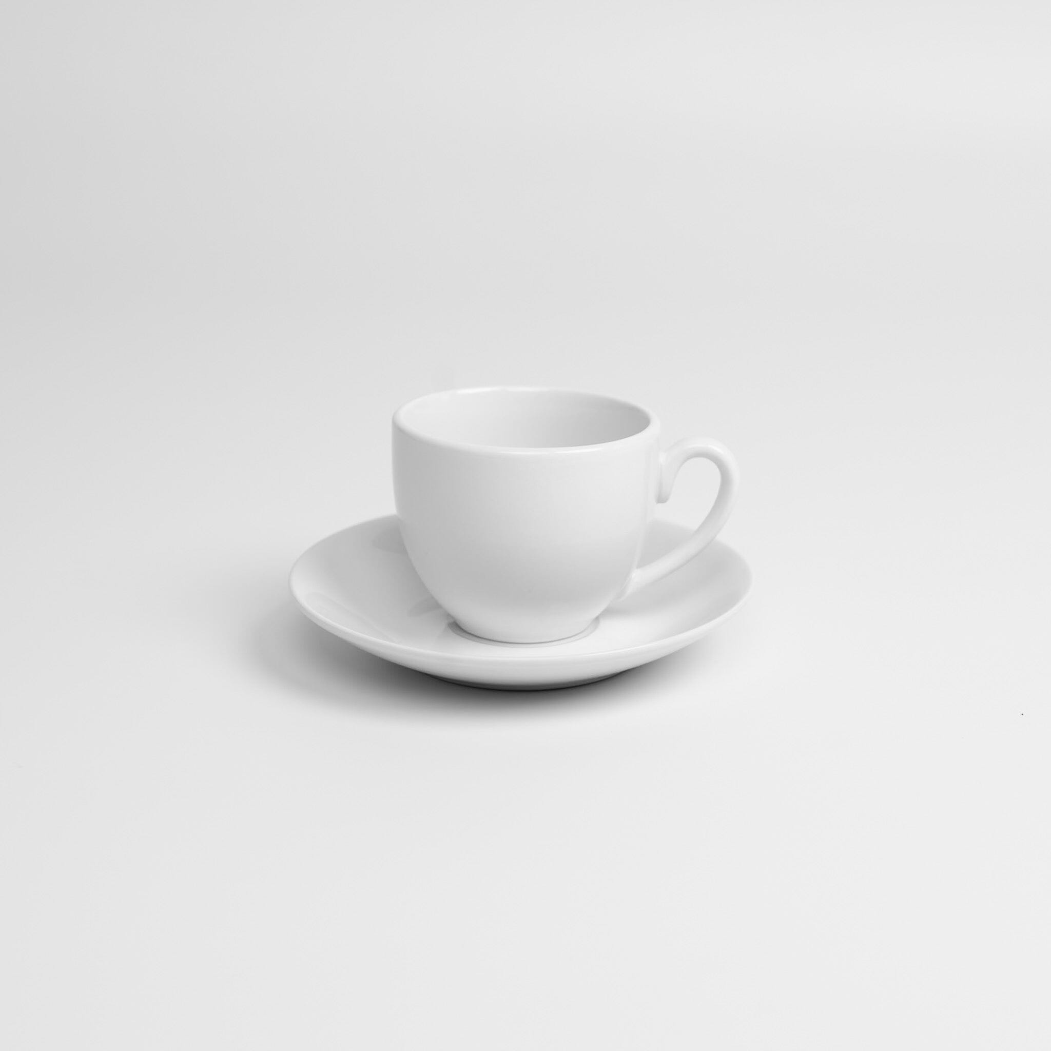 White ceramic cup and saucer on a light gray background