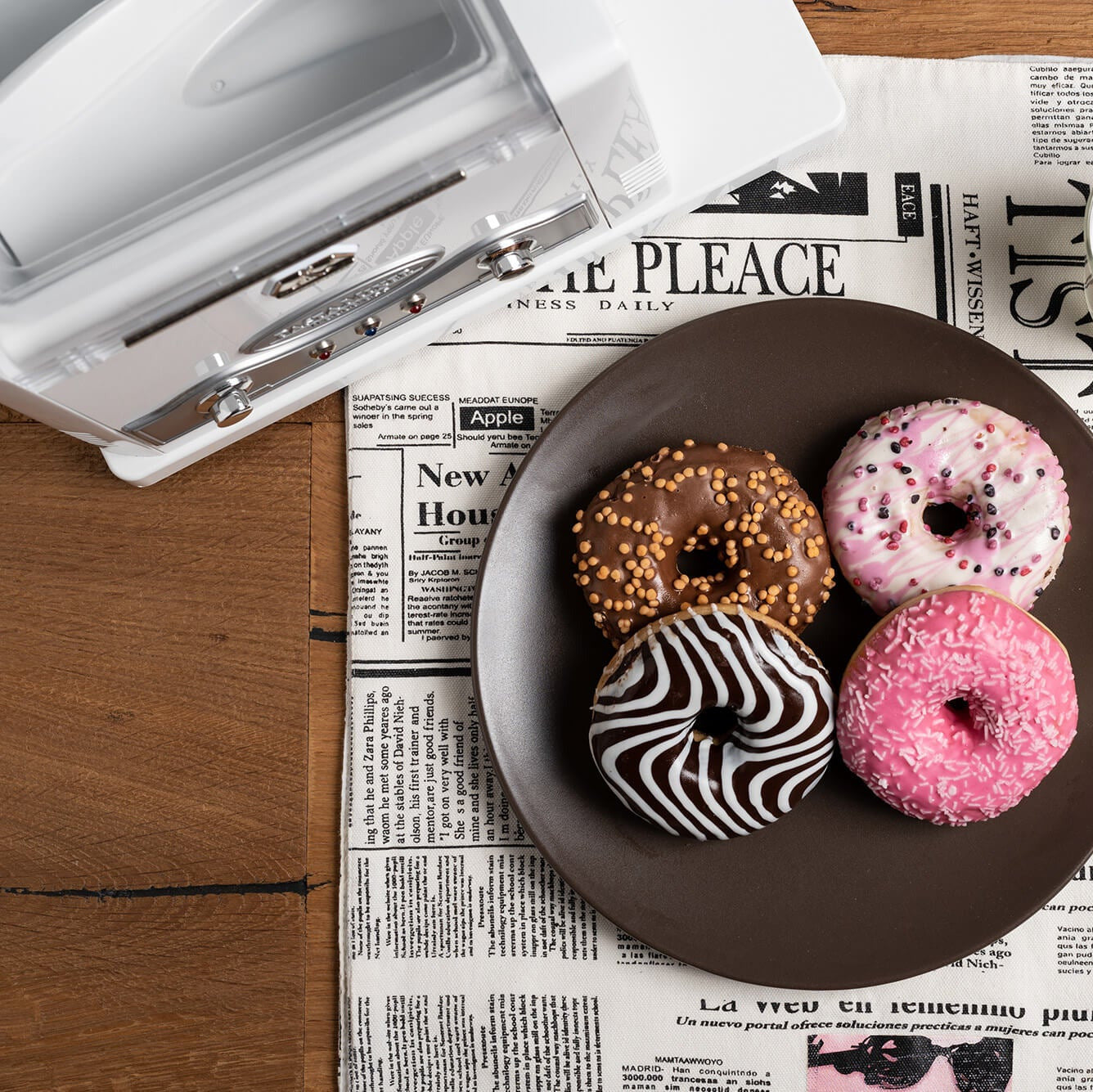Doughnuts on a plate next to a Marcato Pasta Fresca