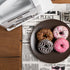 Doughnuts on a plate next to a Marcato Pasta Fresca