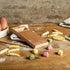 Marcato Rigagnocchi gnocchi and garganelli paddle with rolling pin next to handmade gnocchi on a wooden bench