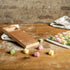 Marcato Rigagnocchi gnocchi and garganelli paddle with rolling pin next to handmade gnocchi on a wooden bench