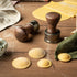 Round ravioli and Marcato Design Round Ravioli stamps on a wooden work surface with fresh pasta in the background