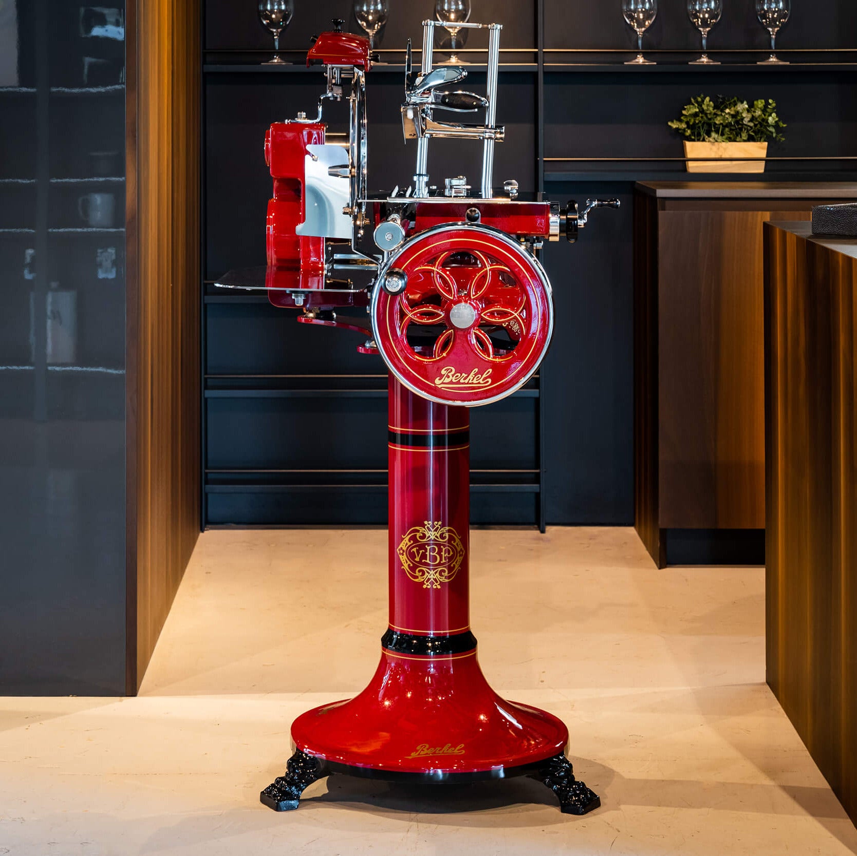 Red Berkel Volano Tribute on a red stand in a modern kitchen