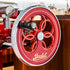 Close up showing the flower flywheel on a red Berkel Volano Tribute Flywheel Slicer