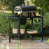ZiiPa Piana wood-fired pizza oven on a vallone trolley, both in Charcoal colour, in a garden setting