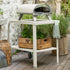 ZiiPa Piana wood-fired pizza oven on a vallone trolley, both in Chalk colour, on a garden patio