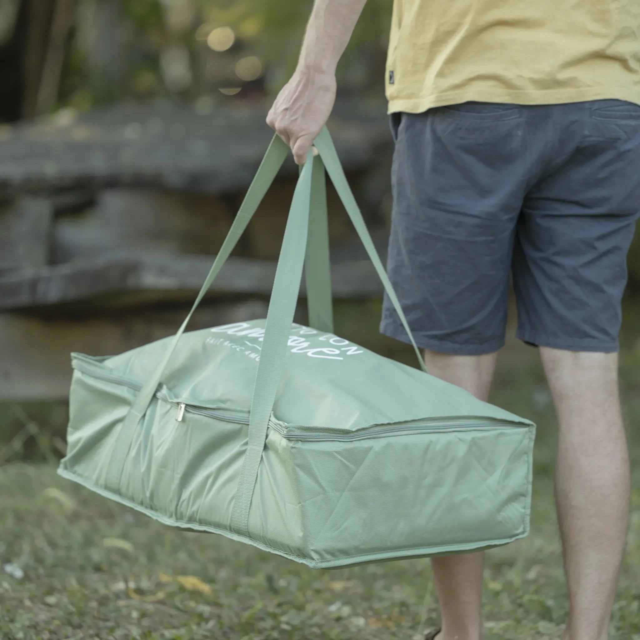 Fontana travel bag for ZiiPa Piana Pizza Oven in Eucalyptus being carried by a man in an outdoor setting