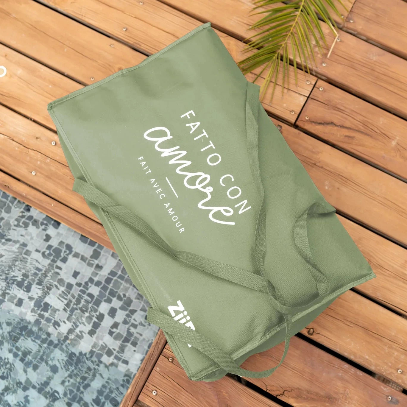 Fontana travel bag for ZiiPa Piana Pizza Oven in Eucalyptus on wooden decking next to a pool