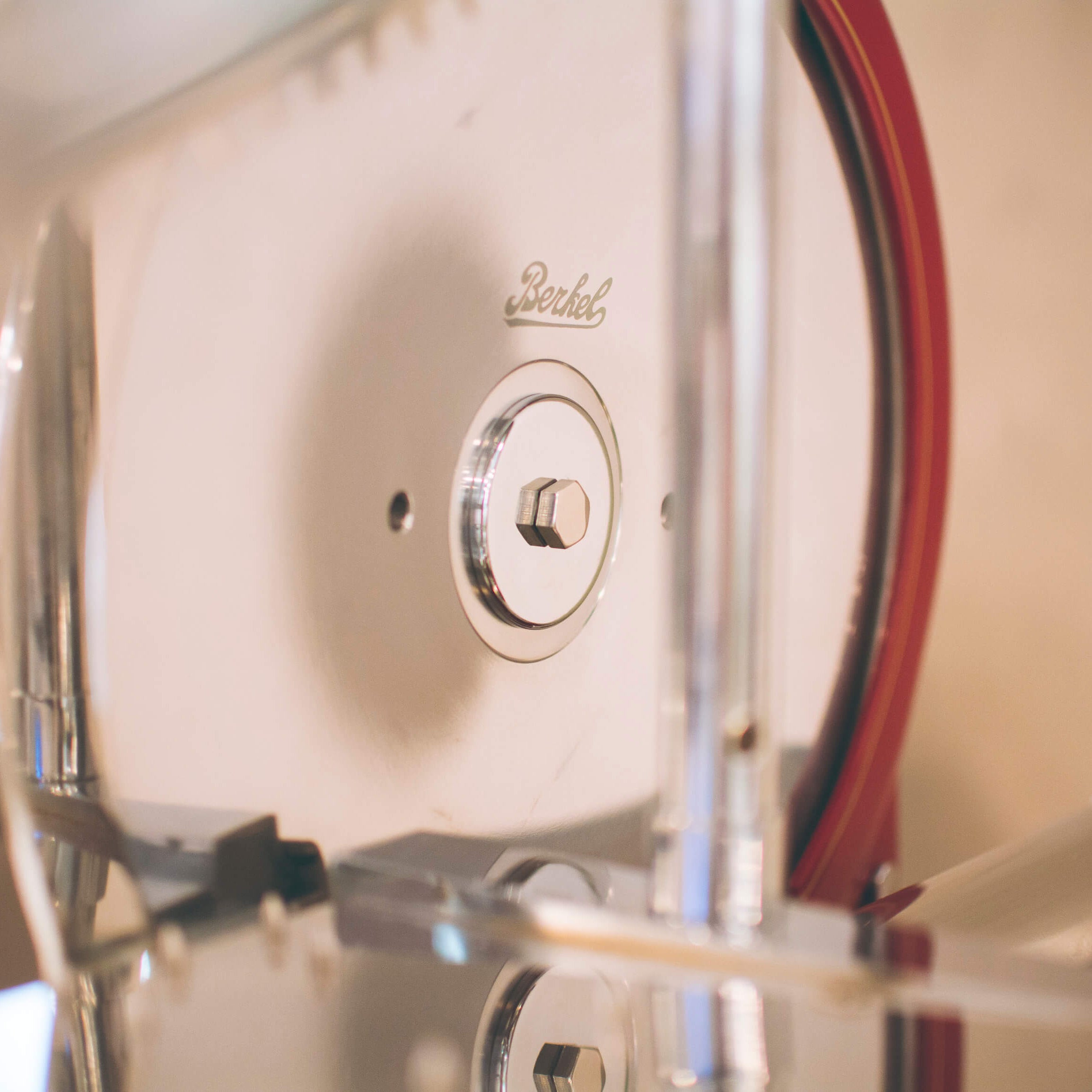 Close-up of a vintage style Volano P15 flywheel slicer, showing Berkel branding on the cutting blade