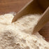 Wooden scoop picking up flour