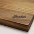 Wooden cutting board with 'Berkel' branding on a white background