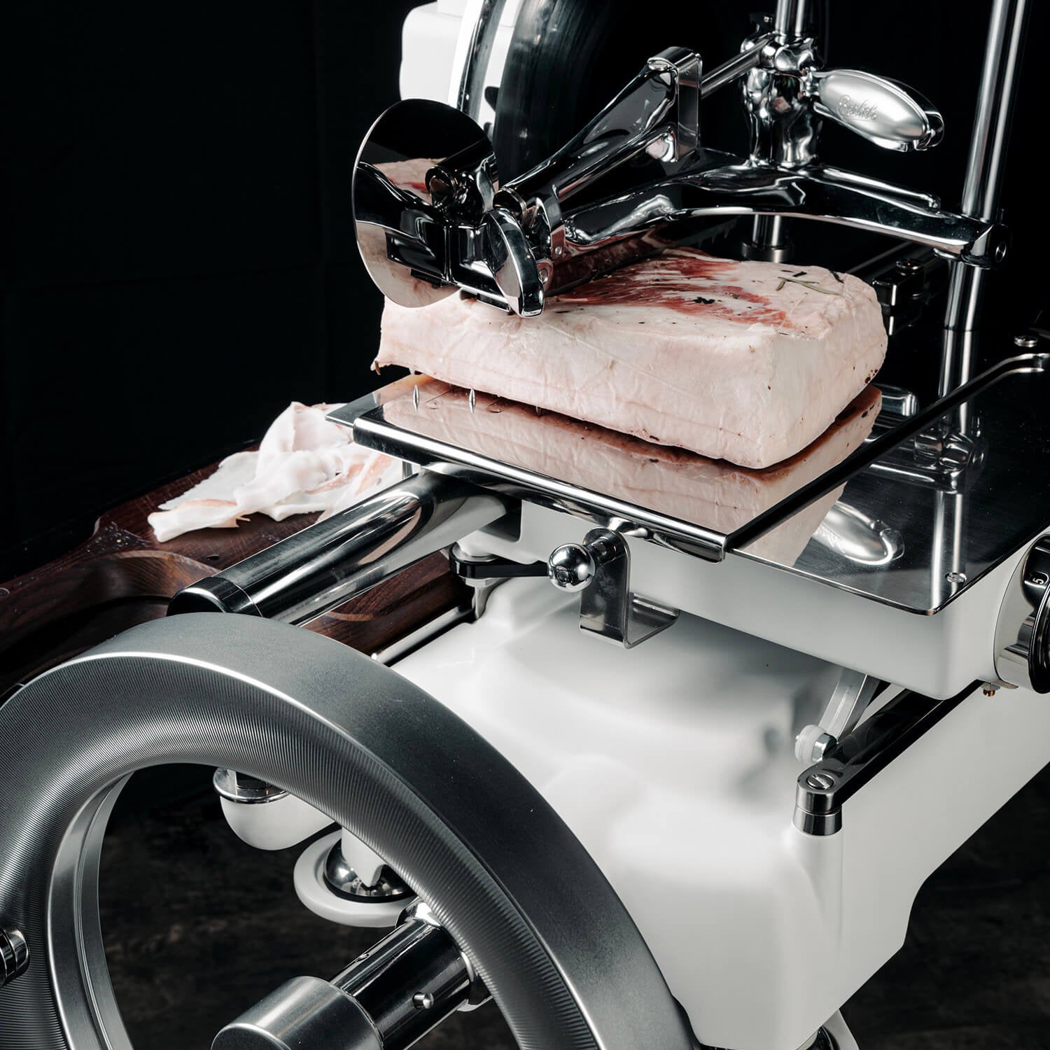 Close-up of Berkel B114X flywheel slicer cutting meat