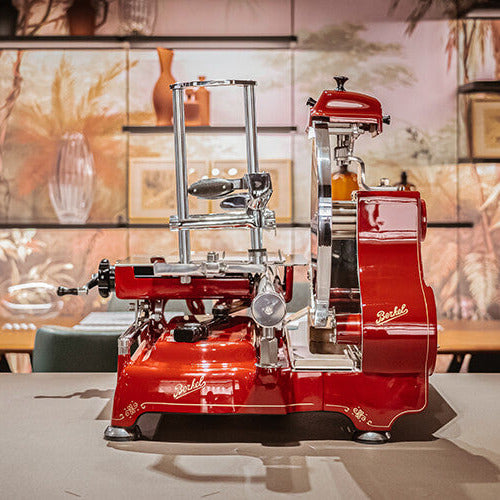 Red Berkel Volano Tribute Flywheel Slicer on a kitchen counter top